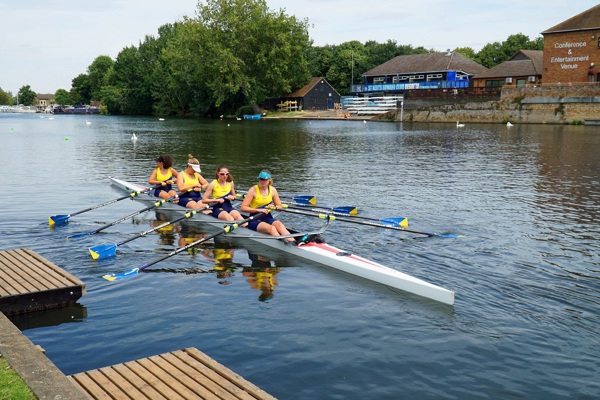 Four rowers on a river